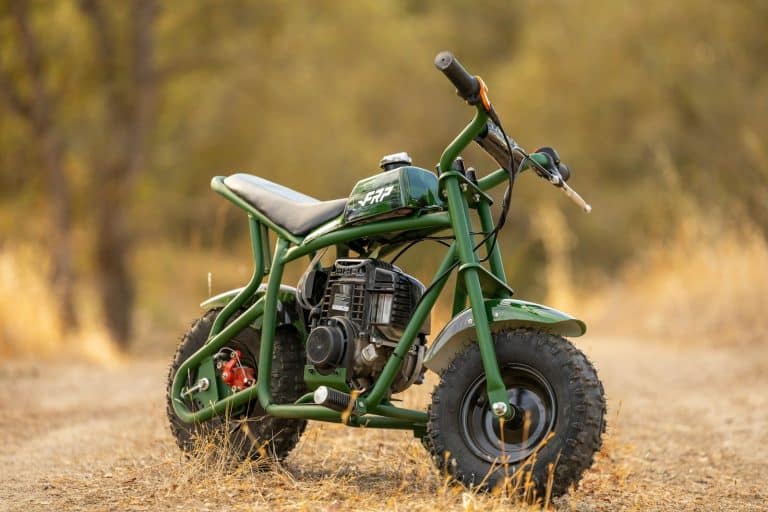 a green motorcycle parked in a field
